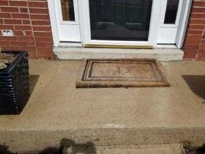 A concrete porch after being pressure washed.