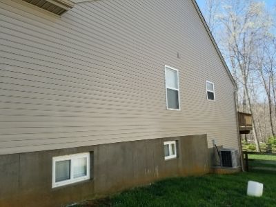 A home with beige siding after being pressure washed.