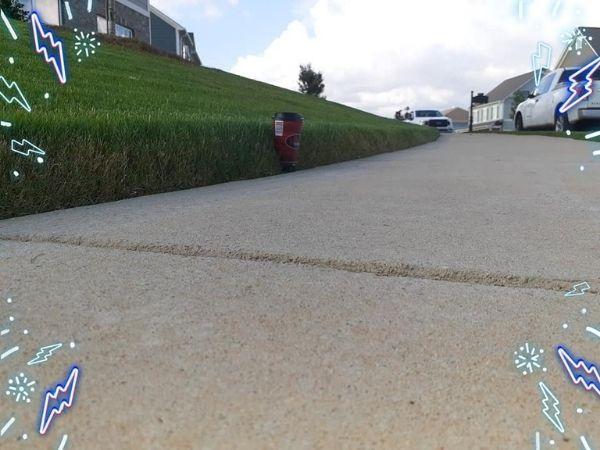 A close up of a sidewalk that has been freshly and neatly edged.